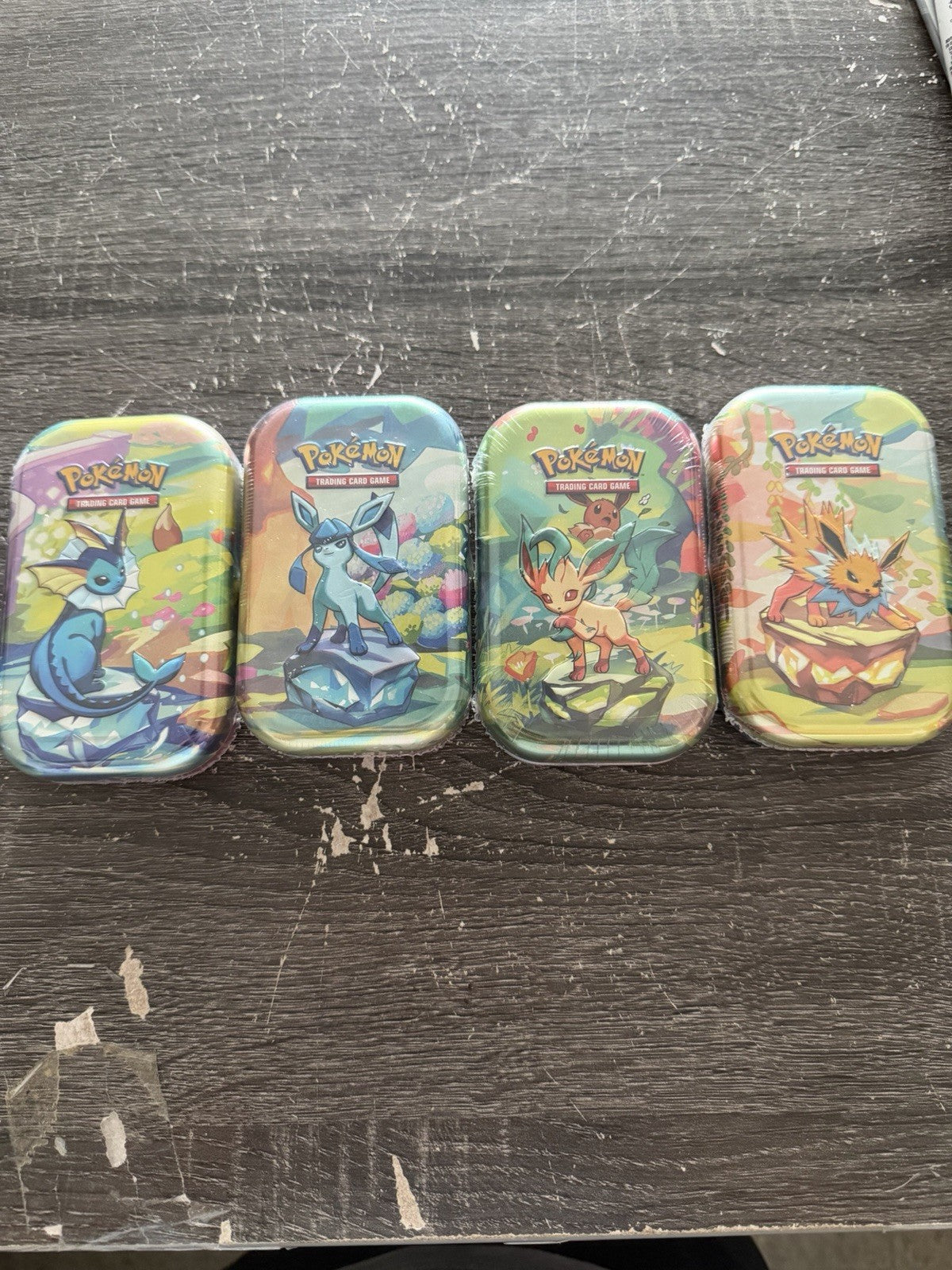 Pokemon PRISMATIC EVOLUTIONS 1 Random  Mini Tins New With Cards Sealed.